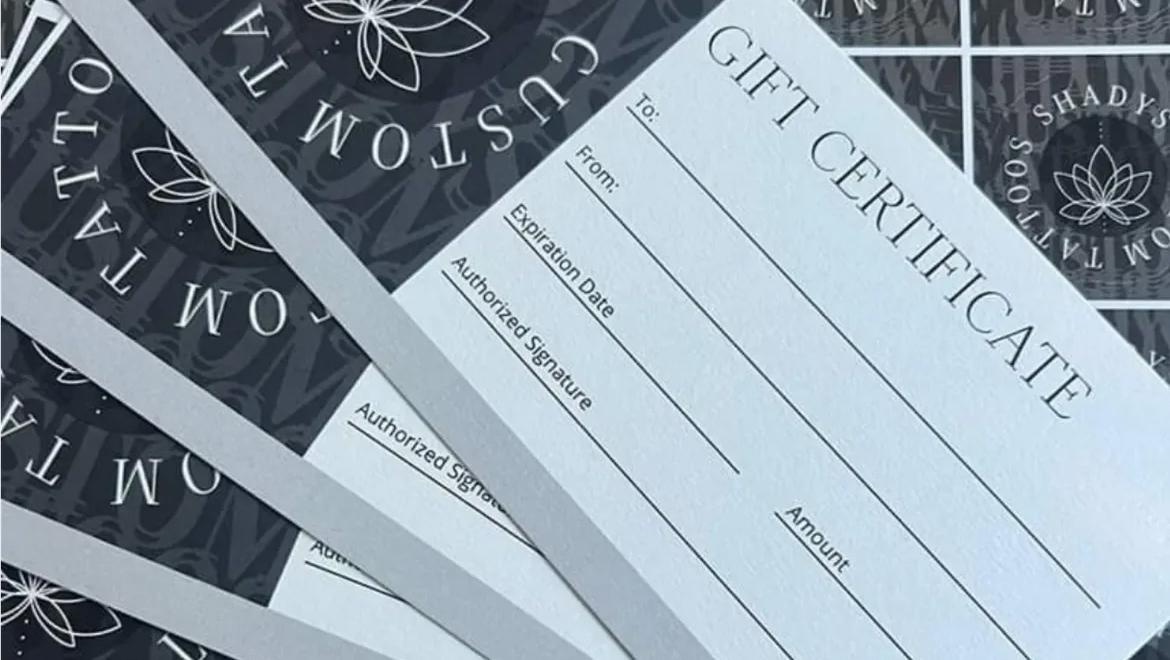 Studio gift certificates laid out on the counter at Shady's Custom Tattoo
