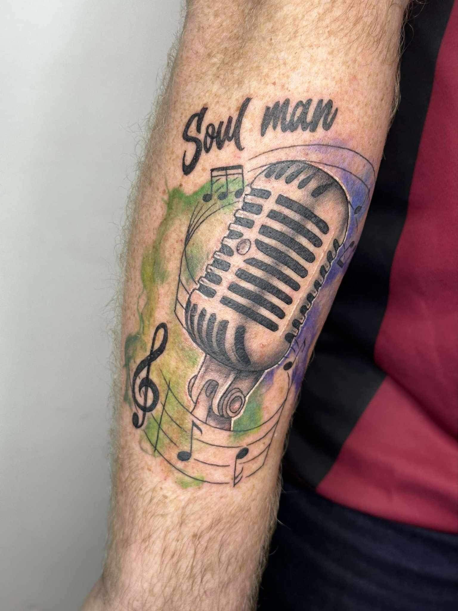 Colour tattoo of a vintage microphone with musical notes, reading Soul Man
