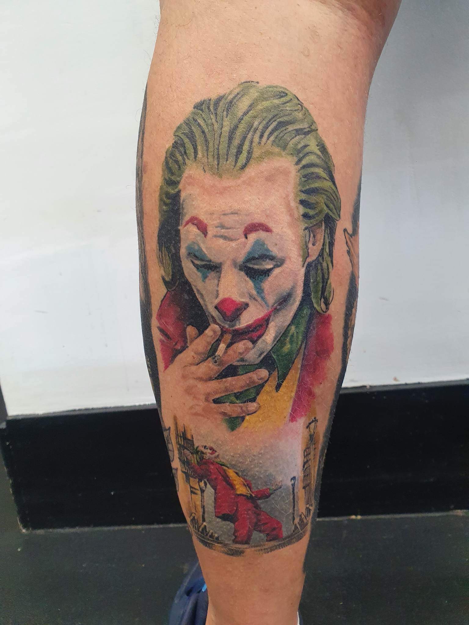 Realistic colour portrait tattoo of a film character with a cigarette, calf piece