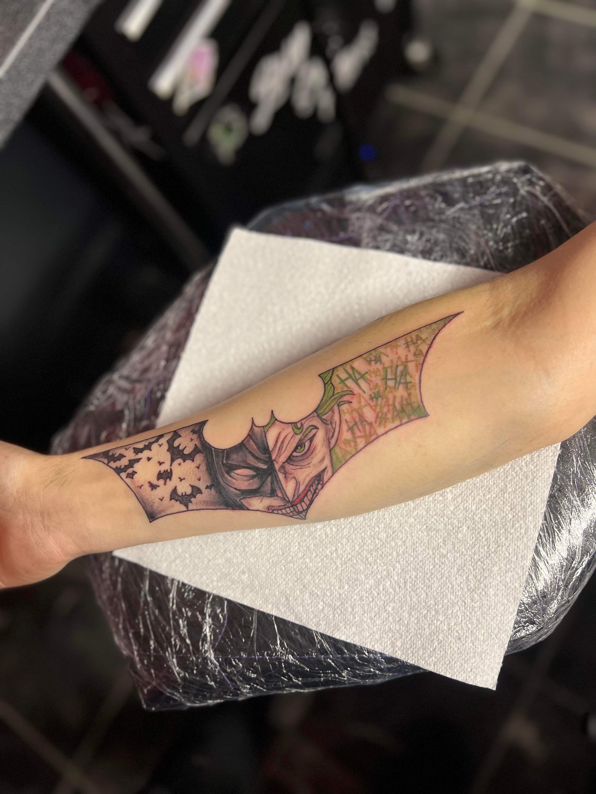 Colour comic villain mask tattoo, forearm